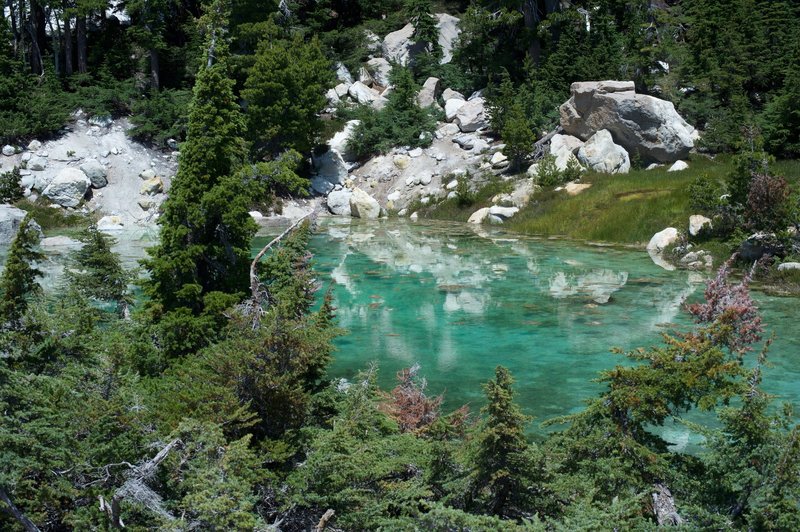 A clear, turquoise pool at the end of the boardwalk.