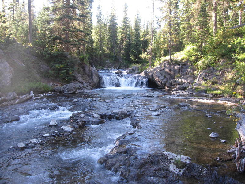 Scout Pool, a naturally heated swimming hole at the base of a small falls.