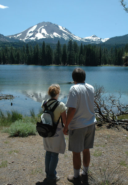 A couple enjoys a view of Lassen Peak from the southern shore of Manzanita Lake.