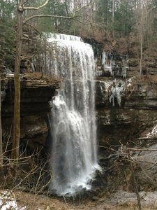 An icy Virgin Falls in mid February. Follow the Virgin Falls Loop Trail in the Virgin Falls State Natural Area, passing three other marvelous waterfalls before reaching the 110 foot waterfall.
