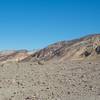 The canyon walls start to rise above you as the different colored rocks indicate different geological types.