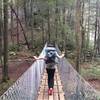 Crossing the bridge to the base of Foster Falls along the Fiery Gizzard Trail.