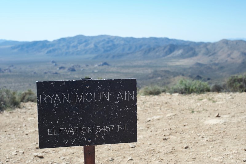 The summit of Ryan Mountain is marked by a small sign. The rest of the park stretches out before you at this point.