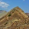 The rugged trail snakes up the Southeast Ridge and nears the summit of Electric Peak.