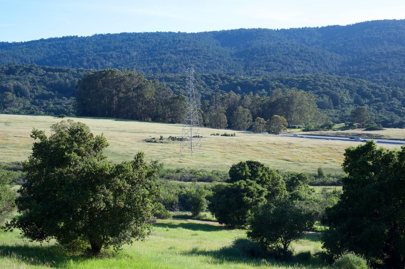 Views of the Sunset Trail, fields, I-280, and the Santa Cruz Mountains stretch out on the right hand side of the trail (west).