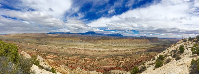 Panoramic view of the valley below and the Henry Mountains in the distance.