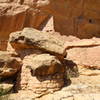 Masonry built around fallen boulders (front), and a multi-story room built to perfectly match the curve of the natural alcove (back). Part of the upper alcove can also be seen in the upper right.