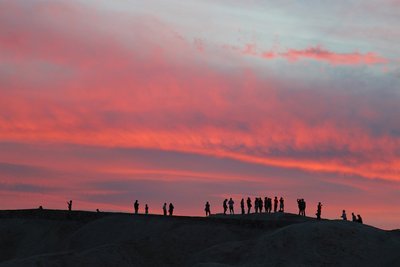 A large group enjoys a sunset.