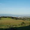 The trail begins to emerge from the woods and views of the San Francisco Bay area stretch before you.