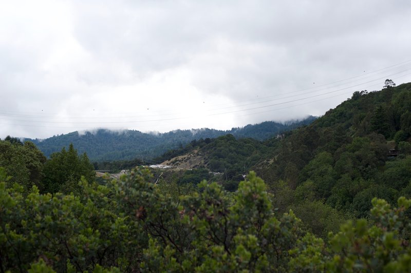 A view of the surrounding hills as low hanging clouds hug the hilltops.