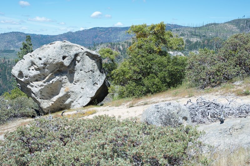 The trail breaks off to the right of the weather station and passes on the right side of this rock.