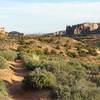 View of sandstone pillars and canyons in distance.