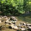 A creek crossing made up of large rocks and boulders.