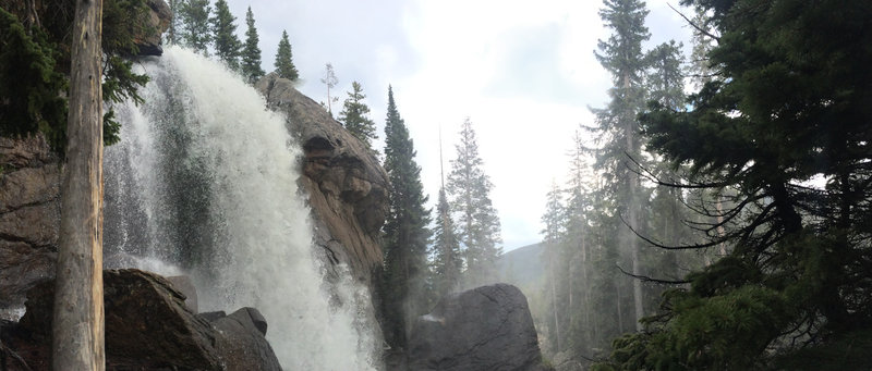 Ouzel Falls, raging, misting visitors as they look at it's majestic wonder.