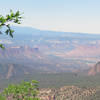 Peeking into view on the left are the snow-capped La Sal Mountains of Utah.