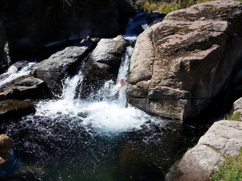 A hidden cave behind a warm curtain of water.