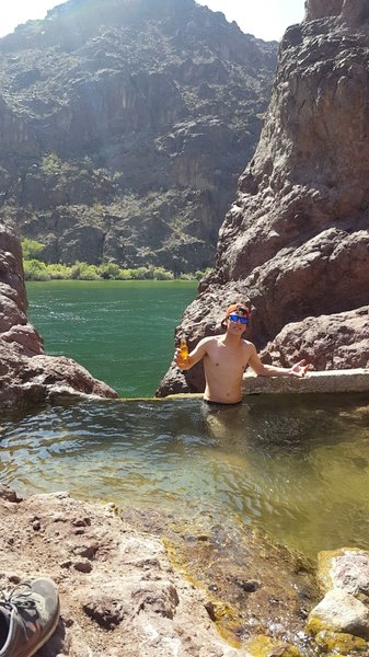 Going for a dip inside of the creek fed Hot Spring over pouring into the Lone Palm Waterfall.