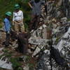 EarthCorps crew moving rocks to help craft the trail!