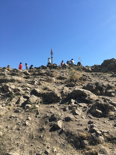 Marker at the peak, and plenty of people enjoying the view!