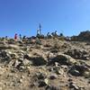 Marker at the peak, and plenty of people enjoying the view!