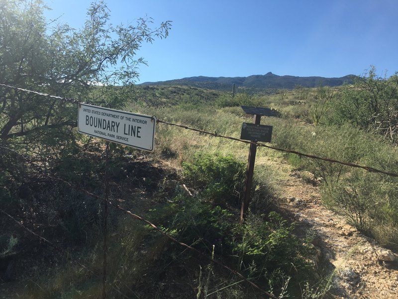 At the 0.6 mile mark is the boundary line to Saguaro NP. There is a gate. The trail leads to a great place to sit and refuel.