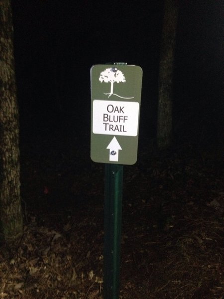 This is a directional sign pointing the way to the Oak Bluff Trail going west from the Alum Hollow Trail.