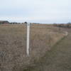 The white posts with the white/blue triangle mark the North Country Trail. For westbound NCT travelers, this is the end.