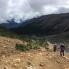 Climbers ascending while looking back on Glacier Basin Campground (near green clearing in photo).