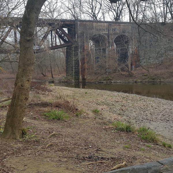 There is an old bridge that crosses the river.