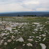 Rock piles with wooden posts mark the trail. The Beaver Creek Fire can be seen in the distance burning in northern Colorado.