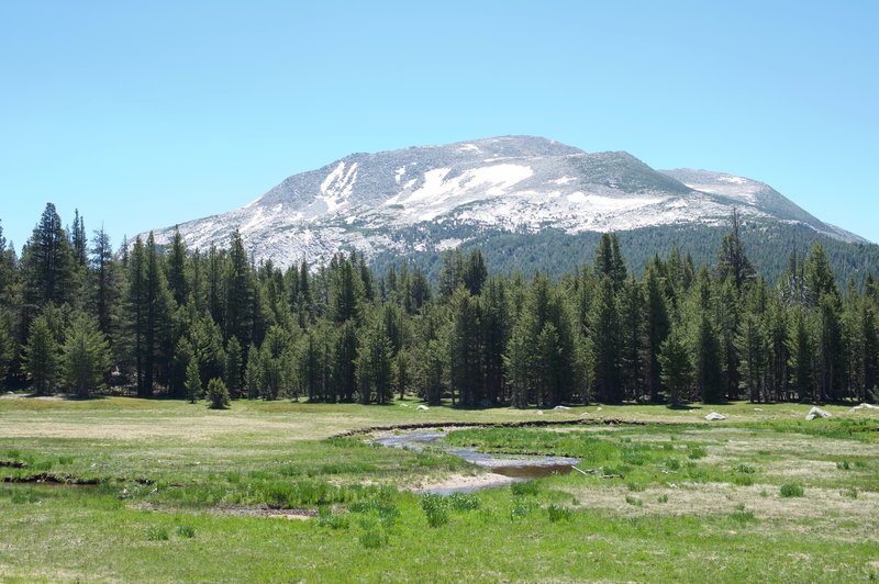 After crossing the road, the trail runs through a meadows with great views of the surrounding mountains.