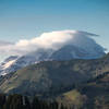 View of Glacier Peak wrapped in clouds from Cady Ridge.