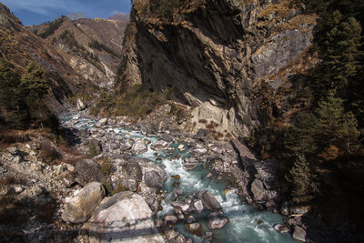 Bridge shadow over river.