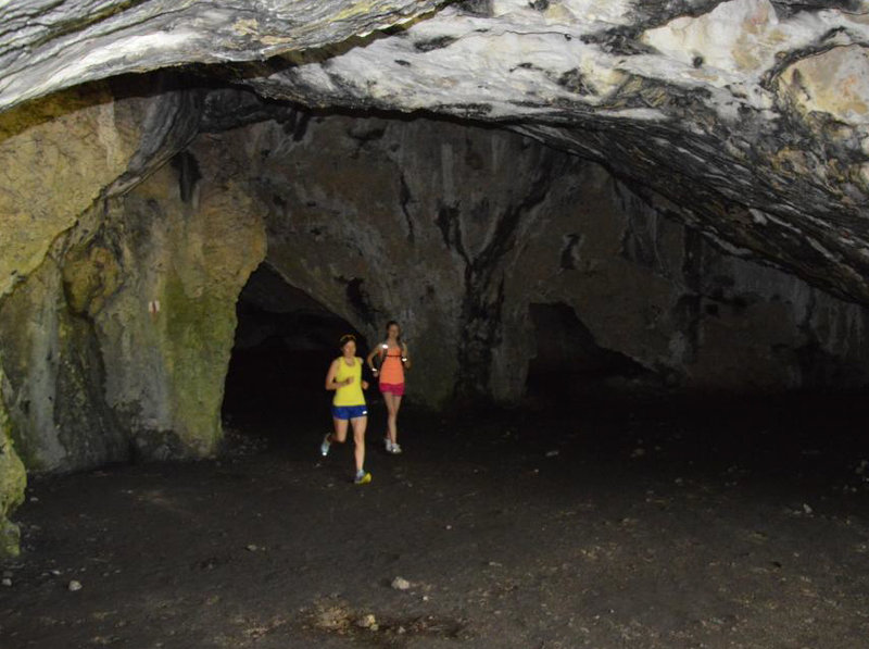 Through one of the numerous caves.