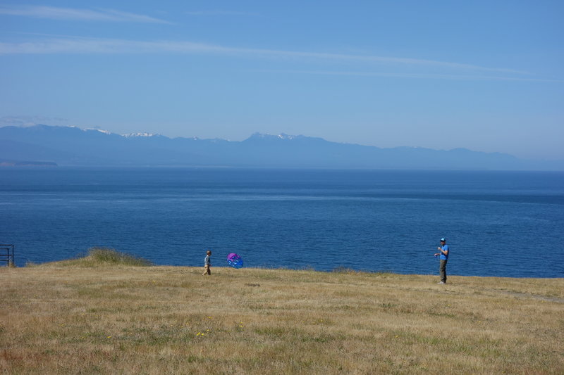 Sunny day at Fort Ebey looking out to the Olympics.  Kites rock!