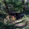 An old, abandoned truck sits off to the side of the trail.