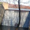 The "waterfall" dam overflow. A bench is available to take in the sight.