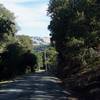 The trail descends along a gravel road.