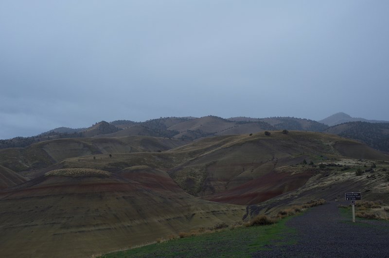 The gravel trail departs the parking area and climbs to the hilltop.