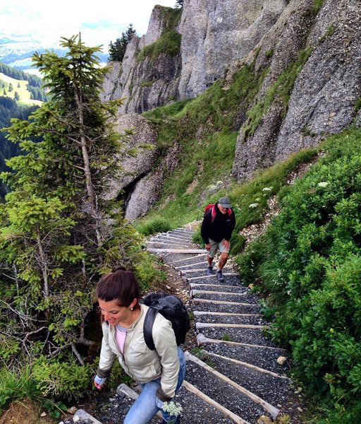 Climbing the final staircase switchbacks toward the ladder.