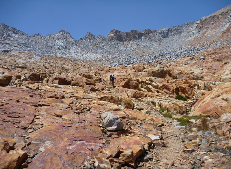 On the north side of Red Peak Pass, just before the switchbacks. Nice transition from grey to red. Red Peak is to the right.