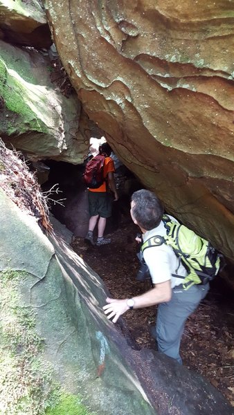 Interesting features in the rock enamor hikers as they squeeze through this passage.