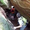 Interesting features in the rock enamor hikers as they squeeze through this passage.