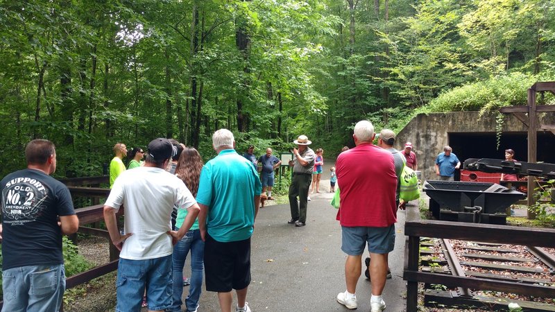 Visitors listen in as a park ranger talks about the coal mining history of Mine 18 along the Blue Heron Loop Trail.