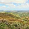 The view to the north depicts lush, rolling grasslands.