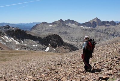 A hiker descends to McGee Pass from Red Slate Mountain.