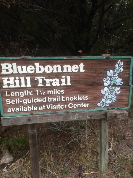 This is a trailhead sign for the Bluebonnet Hill Trail at Cedar Ridge Preserve.