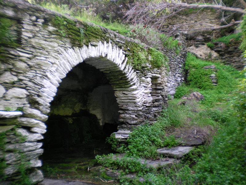 Hones Spring is shadowed by a beautiful stone bridge.