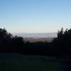 The trail begins to emerge from the woods and views of the South Bay stretch out before you.