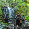 Hikers enjoy the view of Berry Creek Falls.